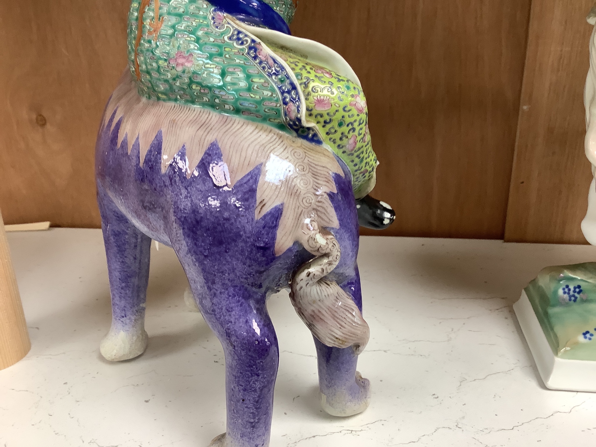 A Chinese enamelled porcelain figure group of an immortal on a mythical beast, Republic period, height 33cm